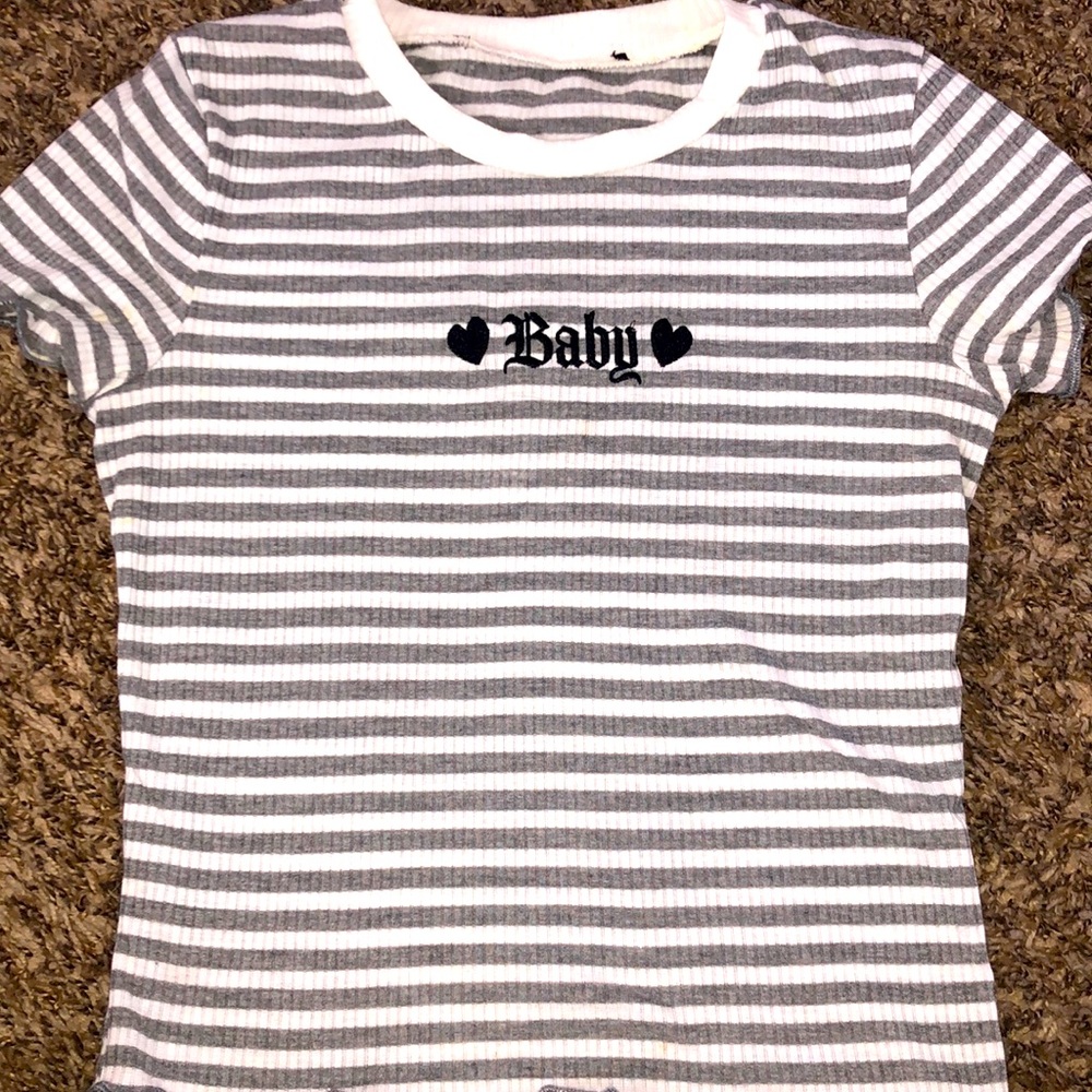 A crops striped shirt with the words baby on it